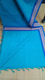 Plain turquoise cotton blouse included with the saree.