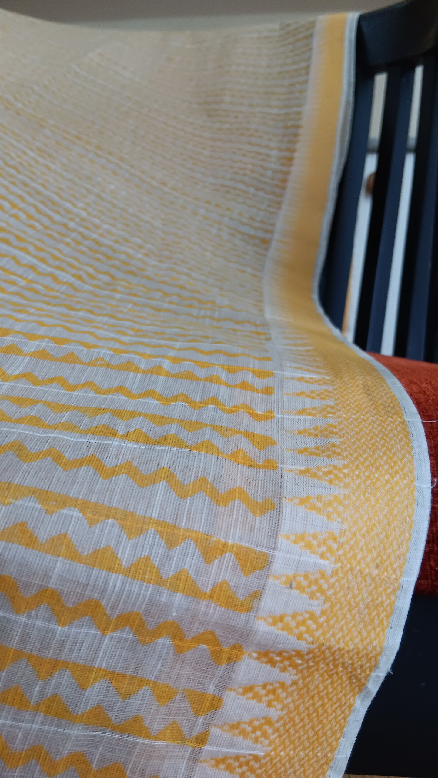 close up view of the temple motifs woven in mustard on the border of a daily use cotton saree