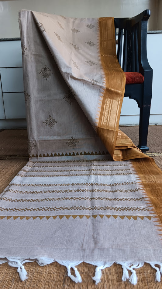 Simple cotton saree with zari border block printed with kolam motifs on the body