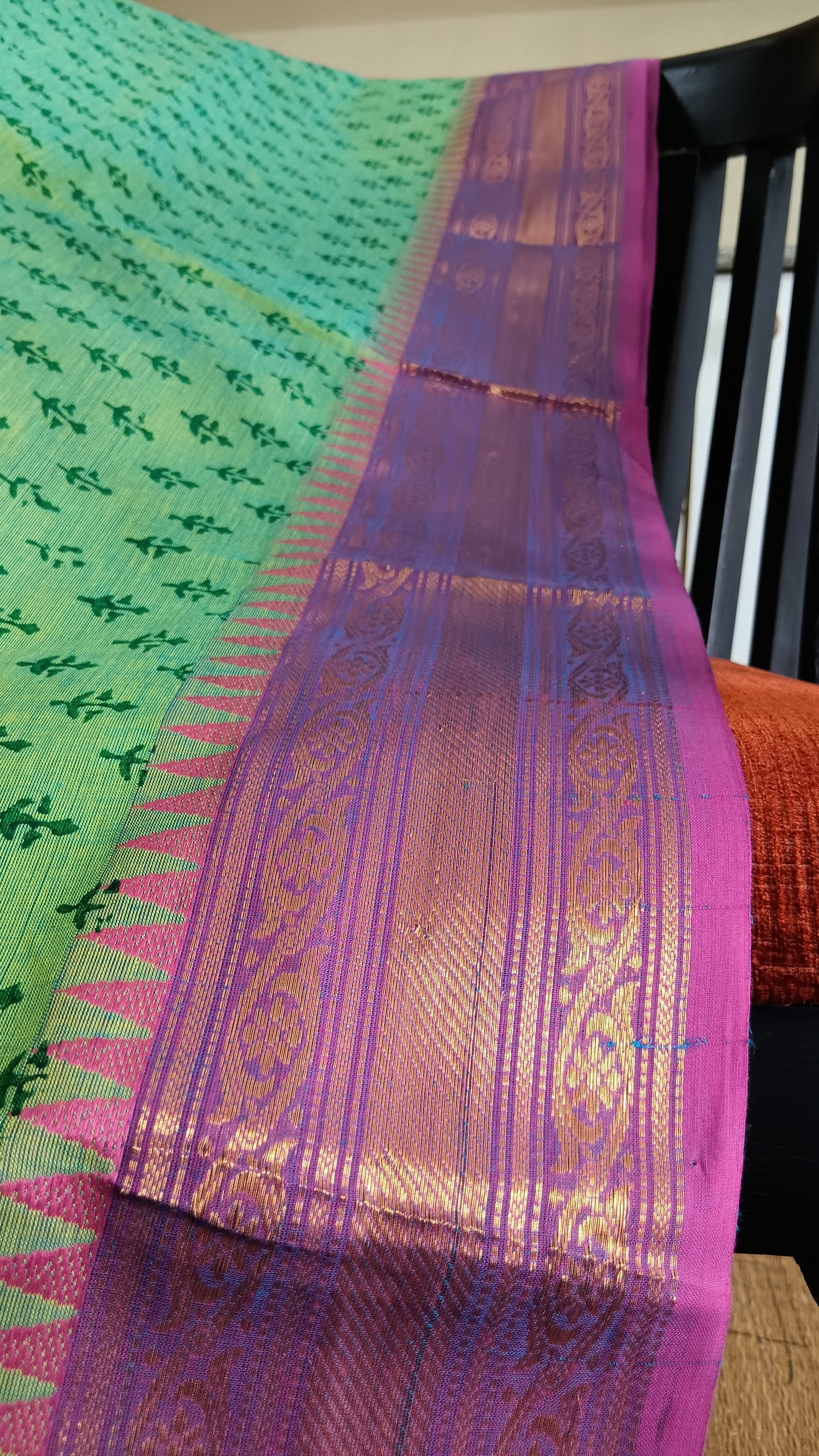 Close up view of the woven pink zari border of a function wear south cotton saree