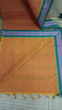 Plain rust cotton blouse included with the saree.
