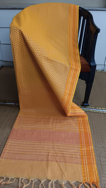 Sunshine All Day: Yellow Cotton Saree with Geometric Prints (Work & Home). This vibrant yellow cotton saree features captivating geometric block prints and a matching thread border, exuding warmth and confidence to brighten your day, be it at work or home