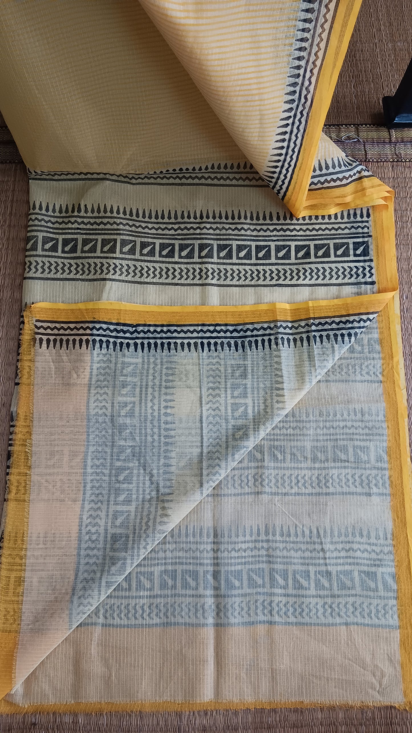 View from the top the plain blouse of a yellow daily wear kota cotton saree